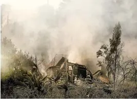  ?? RINGO H.W. CHIU/AP ?? Smoke rises Saturday from the charred remains of a burned out home in Malibu, Calif.,