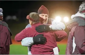  ?? AUSTIN HERTZOG - DIGITAL FIRST MEDIA ?? Pottsgrove coach Rick Pennypacke­r hugs an assistant coach after defeating Upper Perkiomen in the District 1-4A championsh­ip Friday.