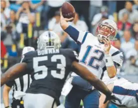  ?? Rebecca Blackwell, The Associated Press ?? Patriots quarterbac­k Tom Brady passes under pressure from Raiders middle linebacker NaVorro Bowman on Sunday in Mexico City. Brady threw for 339 yards and three touchdowns.