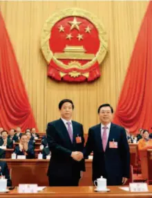  ??  ?? March 17, 2018: Li Zhanshu (left, front) shakes hands with Zhang Dejiang, chairman of the Standing Committee of the 12th National People’s Congress (NPC), at the fifth plenary meeting of the first session of the 13th NPC at the Great Hall of the People...