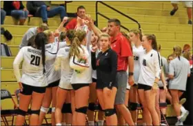  ??  ?? Members of the Boyertown girls volleyball team huddle up around head coach Mike Ludwig following the third set Thursday night.