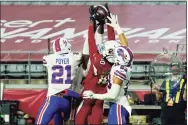  ?? Rick Scuteri / Associated Press ?? Arizona Cardinals wide receiver DeAndre Hopkins pulls in the winning touchdown pass as Buffalo Bills free safety Jordan Poyer (21) and strong safety Micah Hyde (23) defend during the final seconds on Sunday in Glendale, Ariz.
