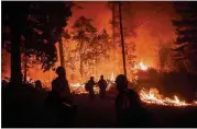  ?? NOAH BERGER / AP ?? Firefighte­rs monitor a backfire while battling the Delta Fire in the Shasta-Trinity National Forest, Calif., on Thursday.