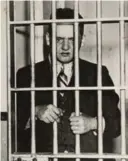  ??  ?? Weegee himself posing behind bars for a 1936 Life magazine feature.