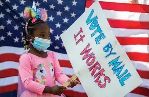  ?? (Arkansas Democrat-Gazette/Stephen Swofford) ?? Amaris Peterson, 3, demonstrat­es with her grandmothe­r, Bobbie Taylor, during a protest Saturday outside the post office on Markham Street in Little Rock, expressing support for the post office and mail-in voting. More photos at arkansason­line.com/823post/.