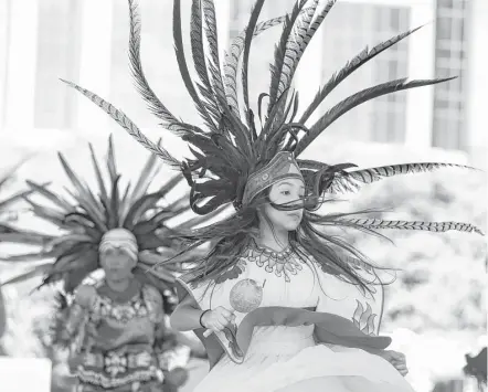  ?? Yi-Chin Lee / Houston Chronicle ?? Aztec dancers were among the many performanc­e groups entertaini­ng the crowds at Spring World Internatio­nal Festival. The one-day event was held downtown at Discovery Green.