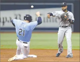  ?? The Associated Press ?? Seattle Mariners second baseman Robinson Cano, right, forces Tampa Bay Rays’ Lucas Duda at second base and relays the throw to first in time to turn double play on Evan Longoria during third-inning AL action in St. Petersburg, Fla., on Sunday.