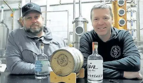  ?? POSTMEDIA NETWORK FILE PHOTO ?? Chris Jeffries and Andrew Murison, of Niagara Falls Craft Distillers, opened their new venture to the public on Feb. 10.