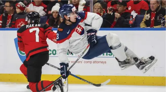  ?? MARK BLINCH/THE CANADIAN PRESS ?? Canada’s Cale Makar takes out Slovakia’s Samuel Bucek during second-period action Wednesday night in Buffalo.