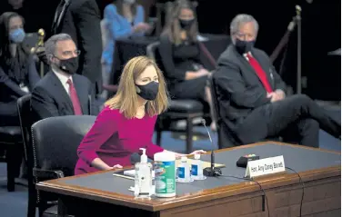  ?? Caroline Brehman, Pool CQ Roll Call via The Associated Press ?? Supreme Court nominee Amy Coney Barrett arrives for her Senate Judiciary Committee confirmati­on hearing on Capitol Hill in Washington on Monday.