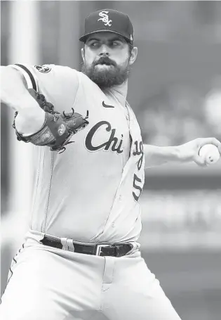  ?? JOHN J. KIM/CHICAGO TRIBUNE PHOTOS ?? White Sox starting pitcher Carlos Rodón delivers against the Cubs in the first inning Saturday at Wrigley Field.