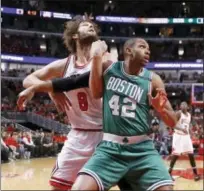  ?? CHARLES REX ARBOGAST — THE ASSOCIATED PRESS ?? The Bulls’ Robin Lopez (8) and the Celtics’ Al Horford vie for position during the first half.
