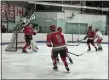  ?? MICHAEL P. PAYNE — FOR THE NEWS-HERALD ?? Mentor goaltender Alex Toth knocks a puck away with his blocker as defensemen Cam Mocny, center, and Brad Backston look on Feb. 1 against Shaker Heights at Thornton Park.