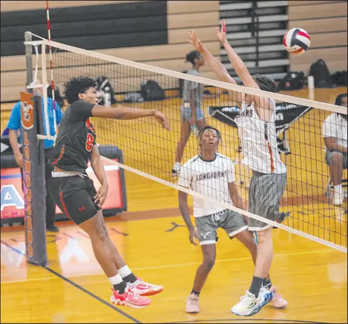  ?? Chase Stevens Las Vegas Review-journal @csstevensp­hoto ?? Mojave middle blocker Malik Cooke sends the ball past Legacy outside hitter Peter Brozda during Mojave’s 25-12, 21-25, 26-24, 25-18 road victory Tuesday night.