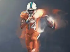  ?? NIKE ?? Wide receiver Jarvis Landry models the Dolphins’ (not the Tennessee Volunteers’) orange Color Rush uniforms.