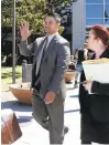  ??  ?? San Jose police Officer Derrick Antonio waves to a camera as he leaves the courthouse.