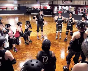  ??  ?? Members of the Rock Town Roller Derby league huddle for a pre-practice pep talk. In 2018, the growing club has taken on a new name, colors and home venue, Arkansas Skatium in Little Rock.