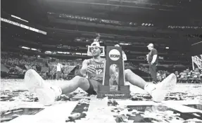  ?? JAMIE SQUIRE/GETTY IMAGES ?? Jared Butler, the Final Four’s Most Outstandin­g Player, enjoys the spoils of Baylor’s first men’s basketball national championsh­ip.