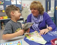  ?? Photo by Katharine Lotze/The Signal ?? Jackie Hartmann, executive director of the SCV Education Foundation, sits down for the camera with Wiley Canyon Elementary kindergart­en student Jude Rumbaugh, 5, to talk about a Lego Star Wars book that will be part of the Bag-o-Books program starting...