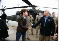  ?? AP/NATI HARNIK ?? Iowa Gov. Kim Reynolds says goodbye to Vice President Mike Pence on Tuesday in Omaha, Neb., after joining him on a helicopter survey of flooding.