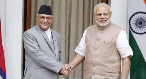  ??  ?? Nepalese Prime Minister Khadga Prasad Oli, left, poses with Indian Prime Minister Narendra Modi