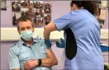  ??  ?? Hospital Porter Phil Skelton receiving his Covid vaccinatio­n.