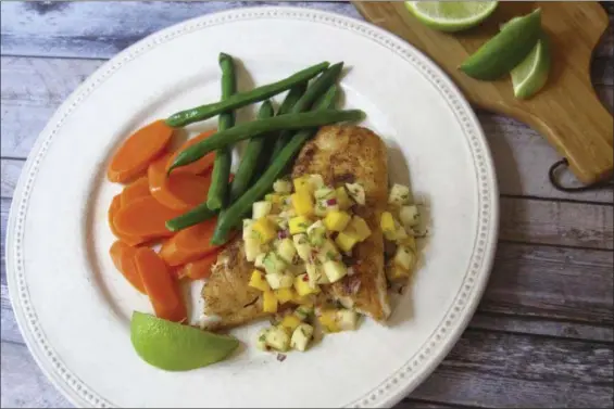  ?? SARA MOULTON VIA AP ?? Spicy sauteed fish with a pineapple mango salsa