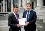  ??  ?? National Spokespers­on for Health Michael Woodhouse and Clutha-Southland MP Hamish Walker with the petition at Parliament yesterday.