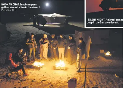  ?? ?? HOOKAH CHAT. Iraqi campers gather around a fire in the desert. Pictures: AFP