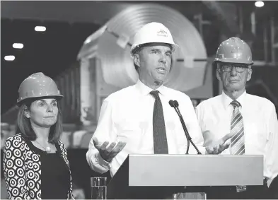  ?? PETER POWER / THE CANADIAN PRESS ?? Finance Minister Bill Morneau speaks to the media about steel tariffs after touring of one of Arcelormit­tal Dofasco’s galvanizin­g mills in Hamilton on Tuesday.