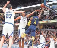  ?? BRIAN SPURLOCK/USA TODAY SPORTS ?? Pacers guard Victor Oladipo (4) lays the ball in against Warriors forward Kevon Looney (5) during the fourth quarter.