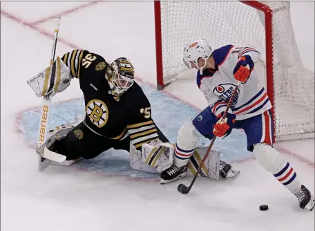  ?? STAFF PHOTO — STUART CAHILL/BOSTON HERALD ?? Boston Bruins goaltender Linus Ullmark (35) makes the kick save and Edmonton Oilers left wing Zach Hyman cannot collect the rebound Tuesday night at the TD Garden.