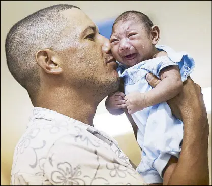  ??  ?? REUTERS A man kisses his son who has microcepha­ly at the Oswaldo Cruz Hospital in Brazil in a photo taken last January.