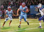  ?? PATRICK HOPKINS — THE NEWS-HERALD ?? VASJ’s Delanoe Harris looks downfield while Patrick Sheridan eyes Gilmour defender Jake Robida on Oct. 14 at Euclid. The Lancers beat the Vikings, 31-14.