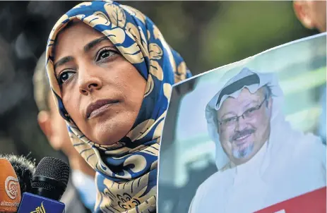  ?? /AFP ?? Dissenters: Nobel peace prize laureate Yemeni Tawakkol Karman holds a picture of missing journalist Jamal Khashoggi during a demonstrat­ion in front of the Saudi Arabian consulate on Friday.