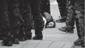  ?? Geert Vanden Wijngaert, The Associated Press ?? A woman wearing a yellow vest is detained during a demonstrat­ion in Brussels on Saturday.