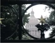  ?? ASSOCIATED PRESS FILES ?? The Texas State Capitol, seen through the south gate, was built from pink granite quarried in Texas Hill Country.