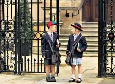  ??  ?? Division at the gates: many uniform policies still stipulate skirts or pinafores for girls