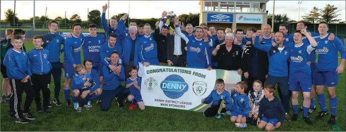  ?? Photo by Domnick Walsh ?? Killarney Athletic players, mentors and supporters celebrate their Premier A Final replay win over Killarney Celtic in Mounthawk Park, Tralee