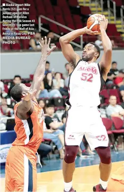  ??  ?? Alaska import Mike Harris (52) goes for a jumper against Allen Durham of Meralco during the PBA Season 43 Governors’ Cup game last Friday at the Mall of Asia Arena in Pasay City.