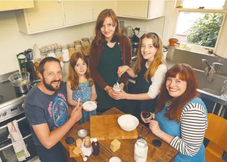  ??  ?? Left: Rebecca Hartnett of Rose Bay with her children William 4, and Eva, 1, has created a national online directory listing "chemical-free, non-toxic" products. Above: The Carter family, Oberon, Maisie, 7, Audrey 14, Xanthe, 11, and Lauren mix up a...