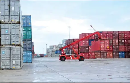  ?? SAHIBA CHAWDHARY ?? A cargo container is lifted for shipping earlier this year at the Sihanoukvi­lle Autonomous Port.