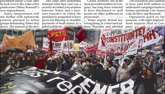  ?? AFP ?? Demonstrat­ors protest along Paulista Avenue in Sao Paulo, Brazil on Thursday to pressure Brazilian President Michel Temer to resign after the Supreme Court gave the green light to an investigat­ion over allegation­s that he authorized paying hush money...