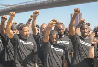  ?? Photos by Mary Altaffer / Associated Press ?? Members of law enforcemen­t raise their fists during a rally in Brooklyn in support of Colin Kaepernick. Legendary former NYPD officer Frank Serpico, below, also was at the event.