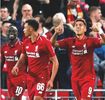  ?? Reuters ?? Liverpool players celebrate the late winner against Paris St-Germain in the Uefa Champions League on Tuesday. The club have been in red-hot form and hope to win at home today.