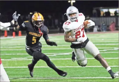  ?? Gail Conner ?? Cedartown’s CJ Washington (27) runs to the outside ahead of a Perry defender during Friday’s Class 4A state qurterfina­l game in Middle Georgia. The Bulldogs won 39-25 and will travel to Columbus this Friday to take on Carver for a chance to go to the state championsh­ip game.