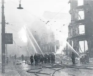  ??  ?? ●Firemen direct hoses on burning buildings during Manchester’s Blitz