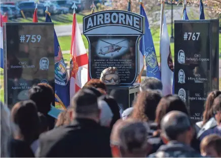  ?? PHOTOS BY DENNY SIMMONS/THE TENNESSEAN ?? The 9 Eagles Memorial is unveiled during a memorial for nine soldiers with the U.S. Army’s 101st Airborne Division (Air Assault) who died when two HH-60 Black Hawk medical evacuation helicopter­s collided during a training exercise last March. The monument was unveiled on Memorial Row in Fort Campbell on Thursday.