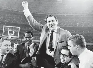  ?? Associated Press file photo ?? Guy V. Lewis is carried off the court at the Astrodome after his team’s 71-69 win over UCLA in 1968. Lewis led UH to five Final Fours, including three straight from 1982-84.
