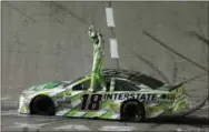  ?? TIM SHARP — THE ASSOCIATED PRESS ?? Kyle Busch stands on his car after winning the NASCAR Sprint Cup race at Texas Motor Speedway in Fort Worth, Texas, early Sunday.